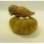A late 19c/early 20c velvet pin cushion with a gilt metal bird thimble holder with two mother of