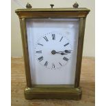 A late 19c French carriage clock in glazed brass 'Corniche' style case with white enamel rectangular