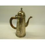 A silver coffee pot in an early 18c style with hinged dome cover and tapering body, having carved