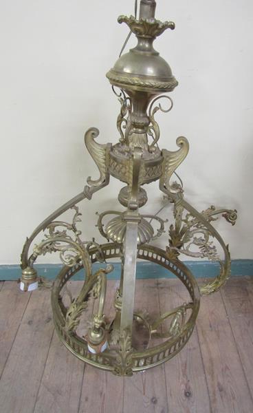 An early 20c gilded brass four light chandelier, leaf and scroll cast, 110cm h, 75cm diam max.