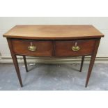 An early 19c mahogany bow front side table having two deep drawers and supported on square