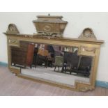 A 19c gilt wood and stucco overmantel mirror with shell and cornet mounts and pediment, 162cm x