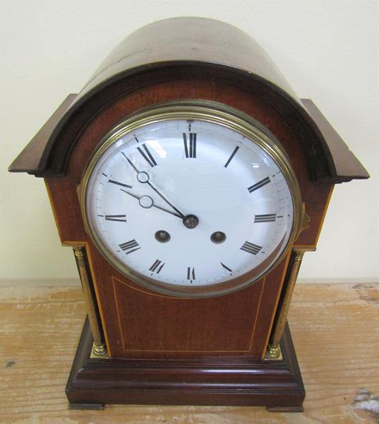 A late 19c French mantel clock in round topped mahogany case with inset brass columns to the front