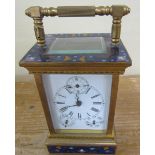 A 20c carriage clock in glazed brass case with champleve enamel panels to top and base and porcelain
