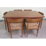 A 1960/70 Danish teak extending drawleaf dining table on tapering circular legs, the table