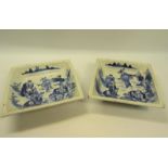 A pair of late 18c Chinese square shallow dishes decorated underglaze blue depicting many figures
