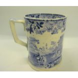 A 19c Staffordshire blue and white tankard decorated with woman and child on a donkey next to