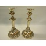 A pair of 19c Sheffield plate candlesticks, single knop with fluted columns on lobed stepped