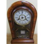 A late 19d American shelf clock by New Haven in round topped walnut veneered case with glazed