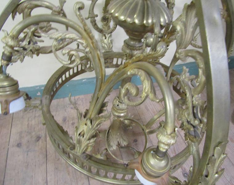 An early 20c gilded brass four light chandelier, leaf and scroll cast, 110cm h, 75cm diam max. - Image 3 of 3