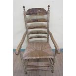 A 19c Dutch open armchair with ladder back and rush seat, the ladder backs rails painted with