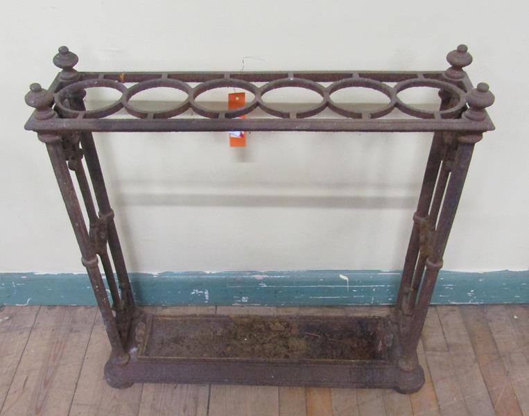 A Victorian cast iron stick stand with trough and six ring divisions, 62cm w, 62cm h.