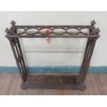 A Victorian cast iron stick stand with trough and six ring divisions, 62cm w, 62cm h.