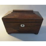 An early 19c rosewood tea caddy of sarcophagus form on compressed bun feet, 23cm w.
