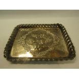 A late 19c/early 20c silver tray of rectangular form with a raised gadroon border, embossed and