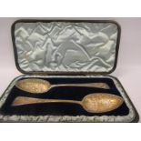 A pair of silver decorative table spoons, the spoons of late Georgian origin, London 1792 with later