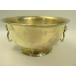 A Victorian circular silver bowl with a ribbed upper rim, lion mark ring pull handles and