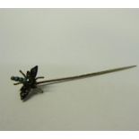 A gold insect stick pin set with Turquoise and Diamond in the form of a Dragonfly. 6cms l.