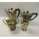 An Edwardian four piece fluted silver tea and coffee service with angular handles, each piece on a