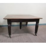 A Victorian mahogany extending dining table, the table top with moulded edge having deep frieze