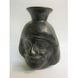 A Raku style pottery facial vase, 16cms h.