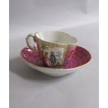 A 19c Meissen cabinet cup and saucer painted with alternate panels of figures on pink scale