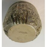 A late Victorian small silver bowl embossed and chased with panels of flowers and fluting. Makers