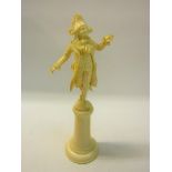 A late 19c carved ivory figure of a Dandy, supported on a tapering plinth with circular plinth.