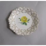 A Meissen dish hand painted with yellow rose within a moulded gilt decorated shell foliage border.