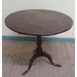 A George III oak circular pedestal tripod table on baluster turned column with splayed legs and