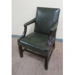 A George III rosewood framed green leather upholstered library chair.