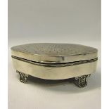 Early 20c silver jewel casket of serpentine form with engine turned sunburst to hinged cover, the