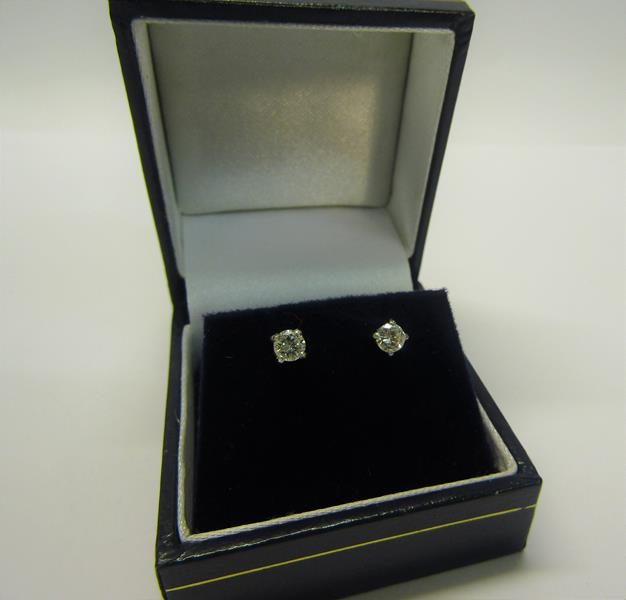 An 18ct gold diamond stud earrings, approx 1/2 carat total.