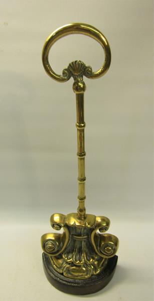 A 19c brass and iron doorstop with central carry handle. 38cms h.