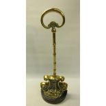 A 19c brass and iron doorstop with central carry handle. 38cms h.