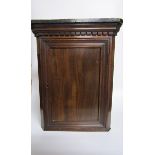 A 19c mahogany hanging corner cupboard of small proportion with a shelved interior enclosed by a