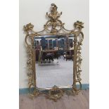 A mid Georgian style gilt wooden stucco wall mirror with scrolling leaf pediment sides and base.