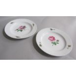 A pair of Meissen soup plates painted with roses. Cross sword marks in blue to base. 23.5cms dia.