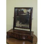A Late Georgian mahogany toilet glass with swing mirror on base fitted with two short drawers. 46cms