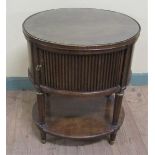 A Georgian style figured mahogany oval low table cross banded and fitted cupboard enclosed by single