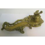 A late Victorian cast brass ink stand with single well under a domed cover with bird finial, with