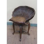 A 19c Italian carved walnut adjustable grotto stool in the form of an open shell, raised on a