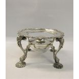 A late Victorian silver plate warmer of circular form supported on four legs with burner, having a
