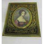 A portrait miniature of a lady wearing a tiara in an oval brass frame. 6.5cms x 8.5cms.