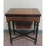 A late Victorian mahogany swivel top games/needlework table with chequerboard top, fitted one long