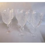 A set of six cut crystal wine glasses with diamond, star and fan design, with facet and cut stems