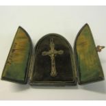 A Victorian white metal crucifix shrine in an arched leather easel case. 10.5cms h.