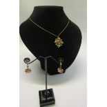 An 18ct gold Pink Sapphire and Seed Pearl pendant necklace together with earrings.
