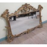 A 19c gilt wooden stucco over mantel mirror with oval bevel edge plate within split column pilasters