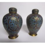A pair of 19c Indian brass and enamel tea canisters of baluster form decorated with ovoid panels